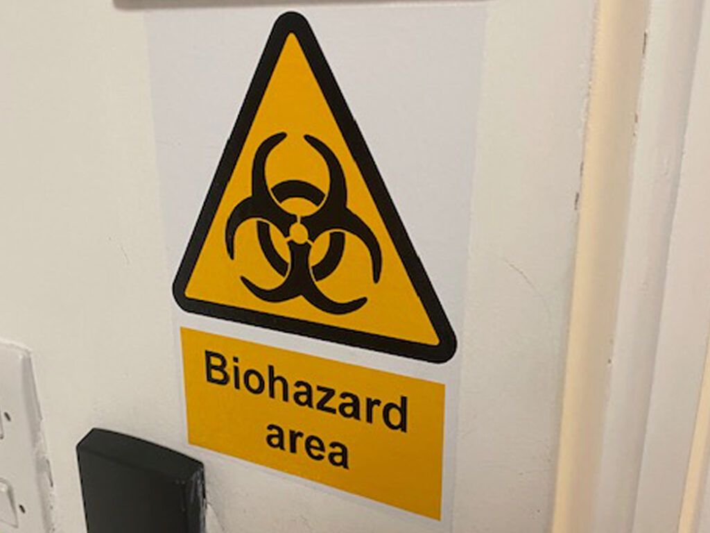 biohazarrd-cleaning-5 Warning sign indicating biohazard area due to presence of human waste contamination